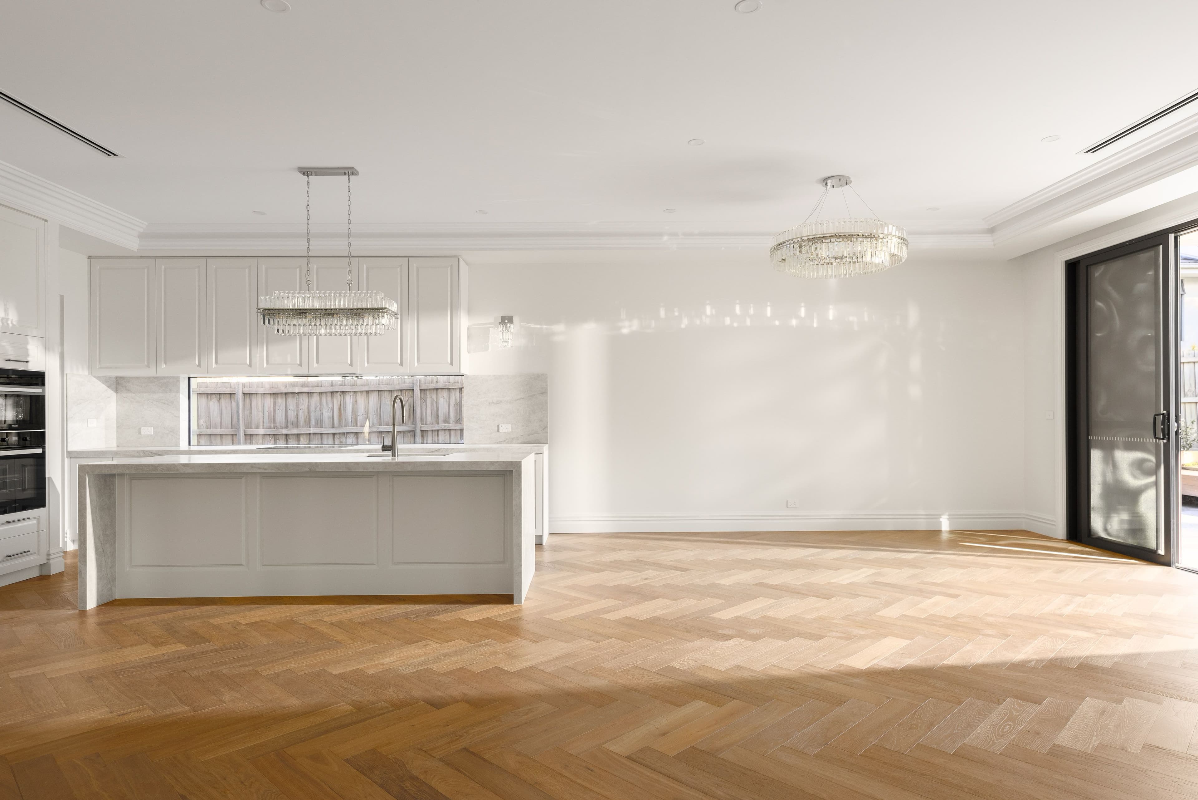 Smoked Brown herringbone flooring around a stone island in a Balwyn kitchen.