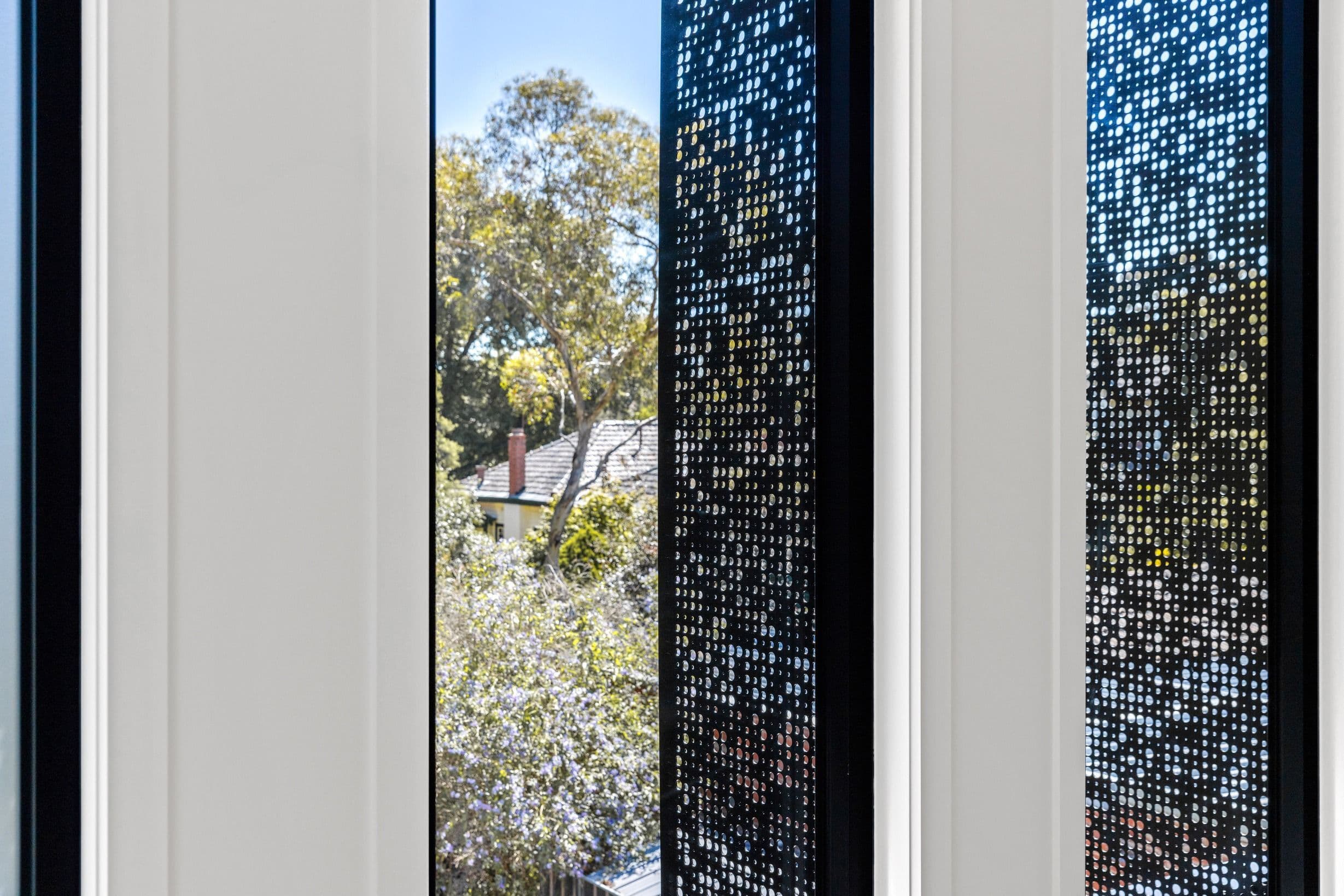 Architectural window screen detail in the completed Glen Iris residence.