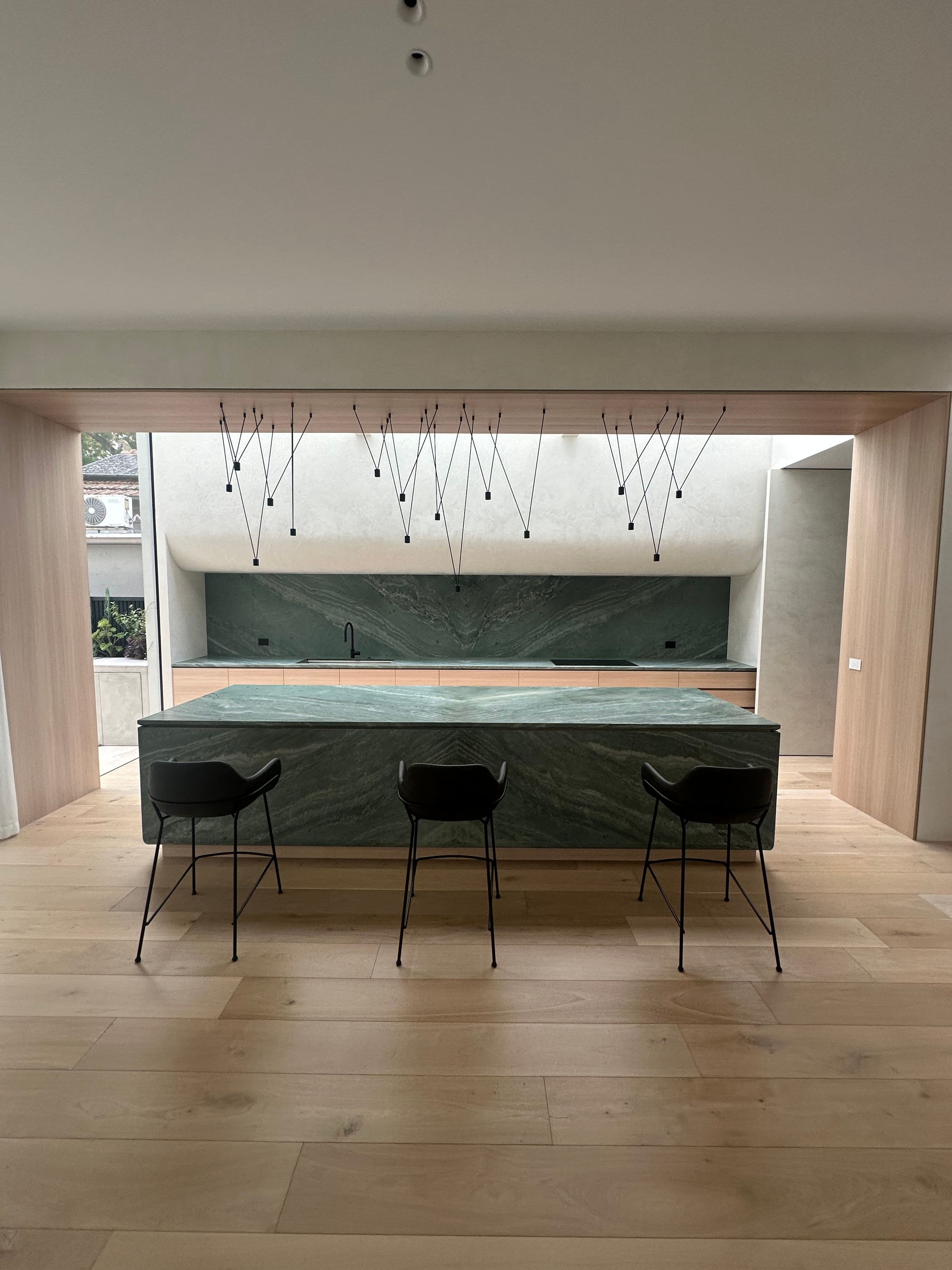 Cashmere engineered oak flooring surrounding a stone kitchen island in Kew.