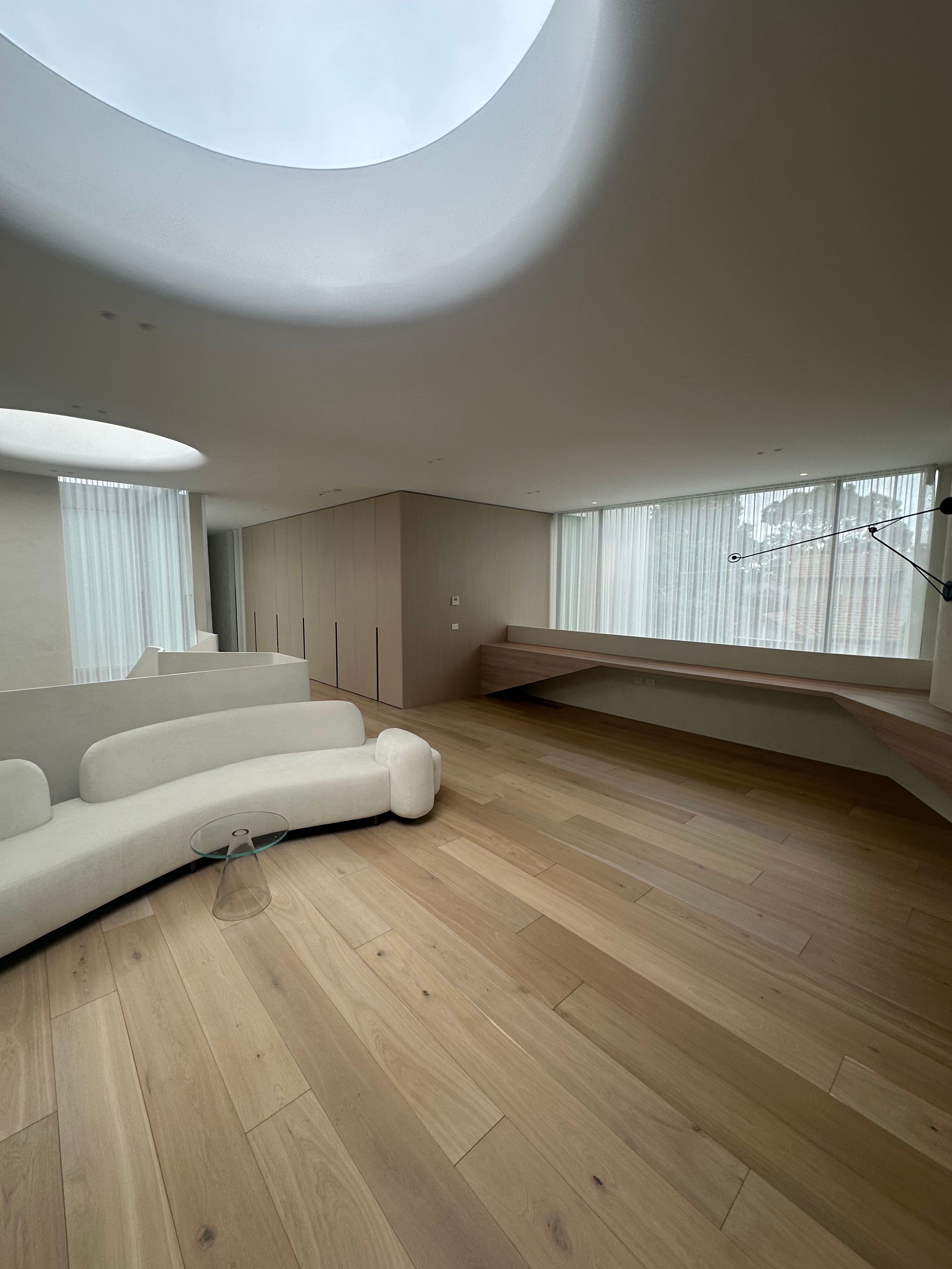 Cashmere engineered oak flooring in a curved Kew living room.
