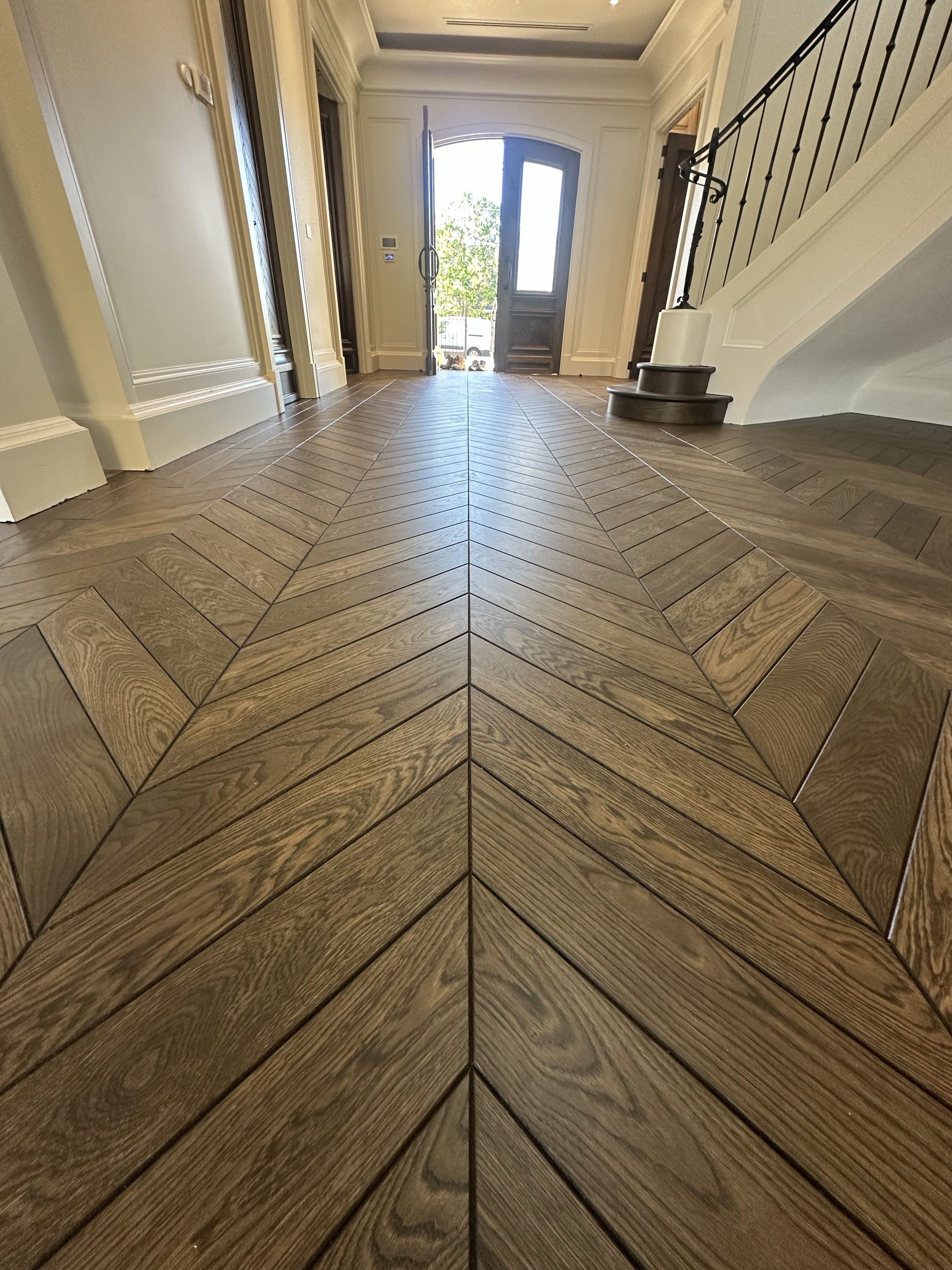 Solid European oak chevron flooring with a 3 mm bevelled edge in a residential entrance.