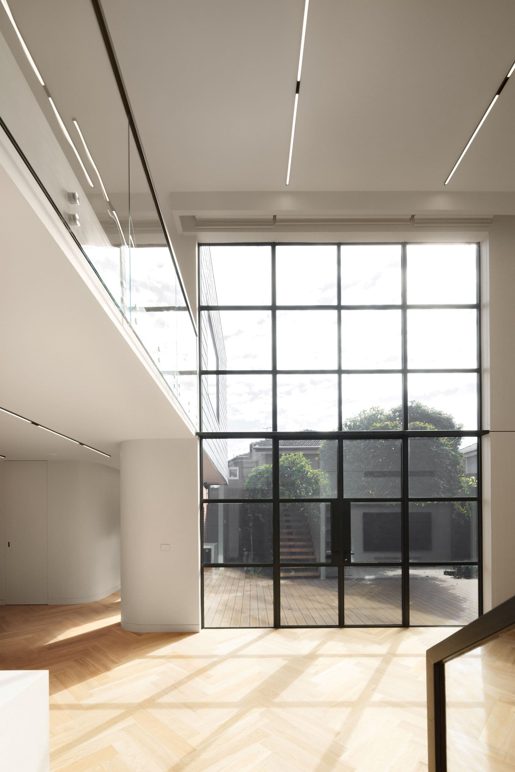 Natural Oak herringbone floor pattern beside full-height windows in Kew.