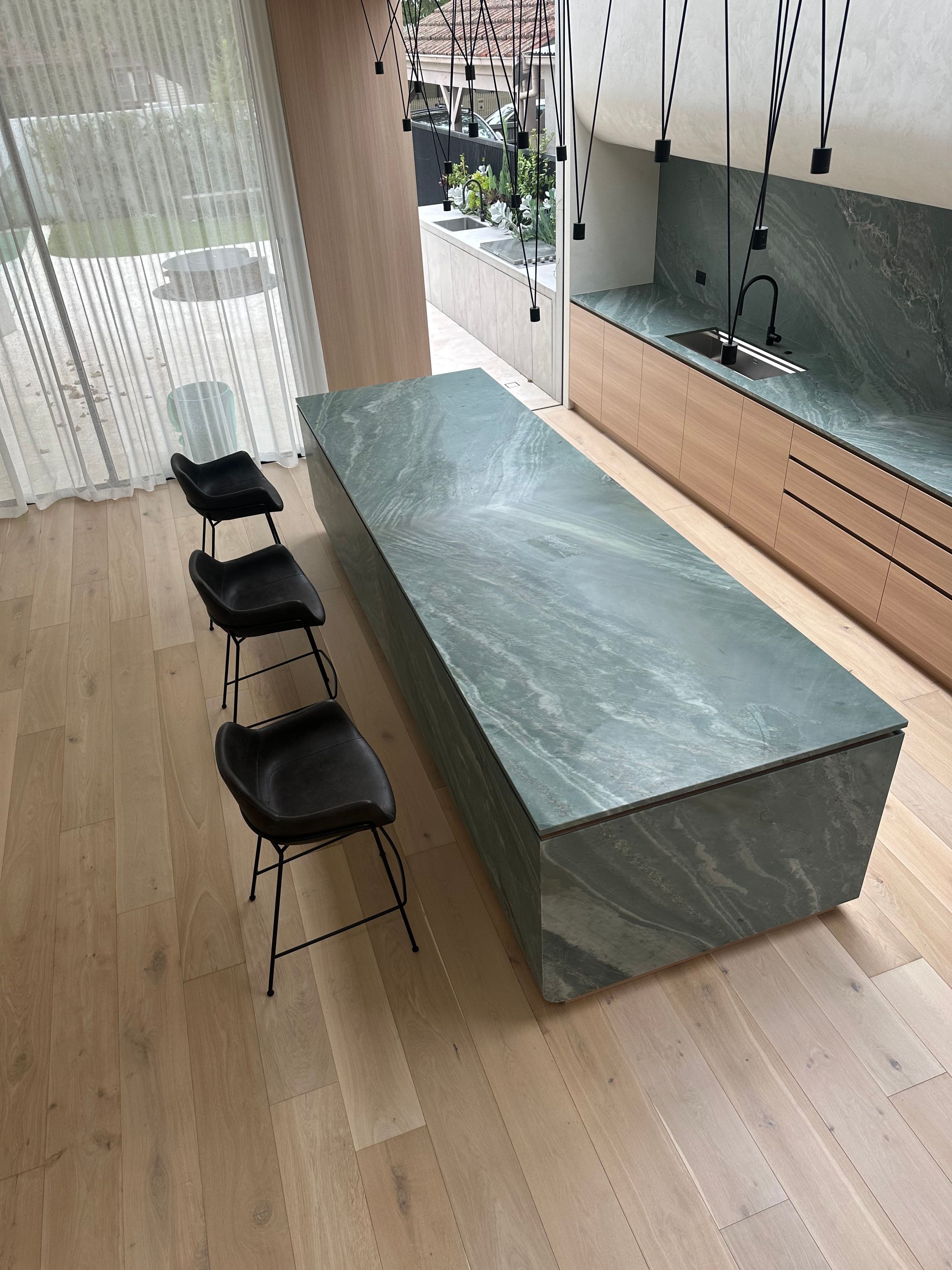 Cashmere engineered oak flooring beneath a stone island in a Kew kitchen.