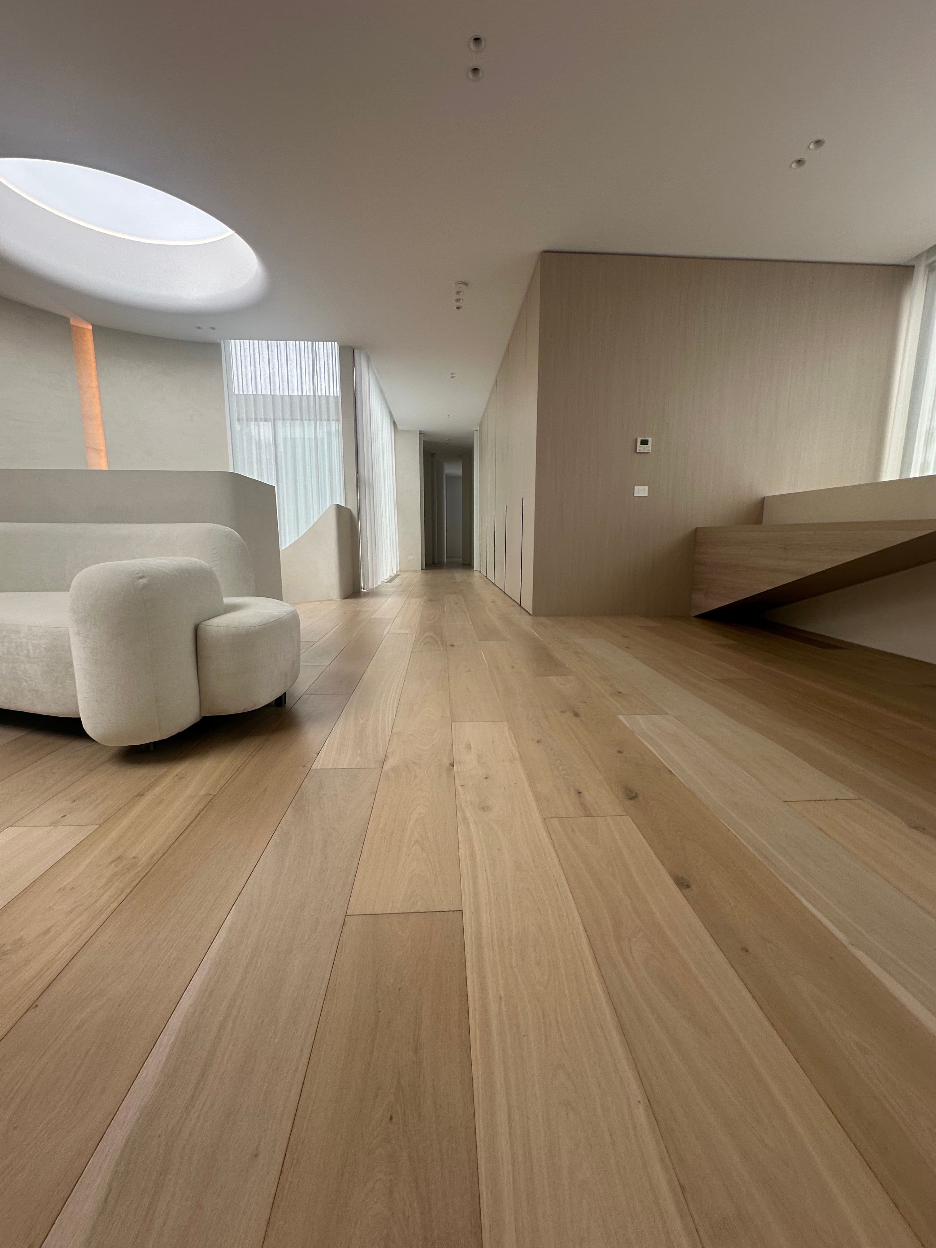 Wide-plank Cashmere engineered oak flooring through a Kew living space.