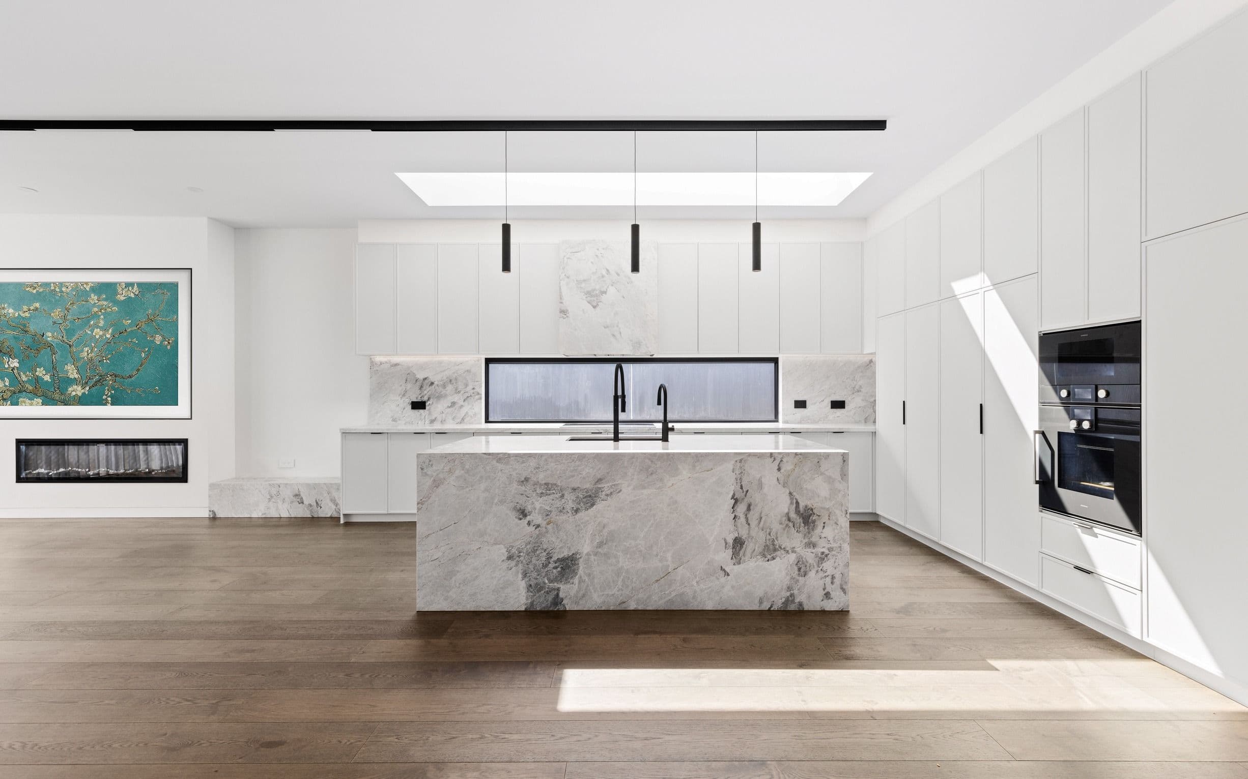 French Grey oak flooring surrounding a marble island in a Glen Iris kitchen.